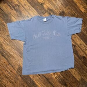 baby blue 2000s anvil tag with a salt lake city utah graphic